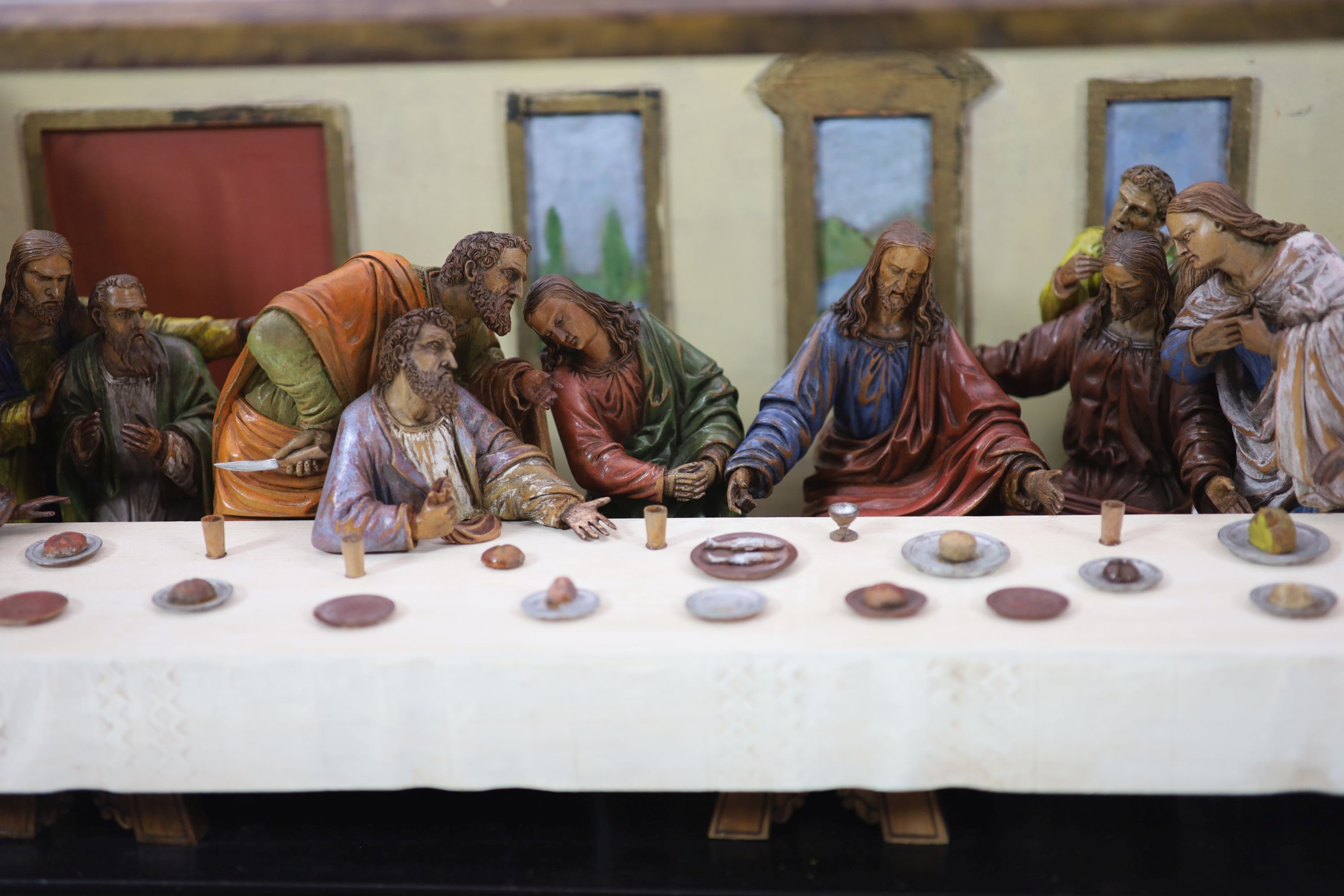 Attributed to Hans Mayr (active 1870) - a carved and painted limewood tableau of The Last Supper, after Leonardo da Vinci, dated 1872 32cm high, 94 x 33cm.